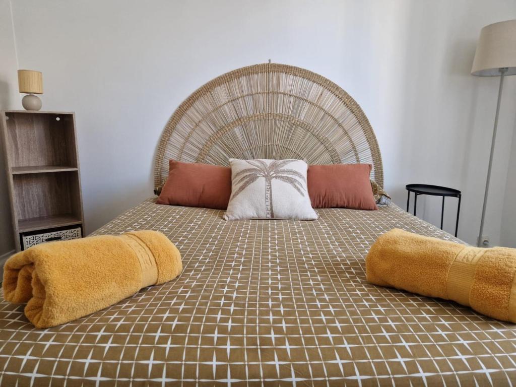a large bed with two pillows on top of it at Beau T3 avec grande terrasse centre Alès in Alès