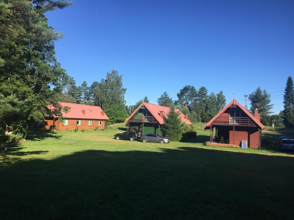 a house with a car parked in a yard at Dar Lasu in Szczytno