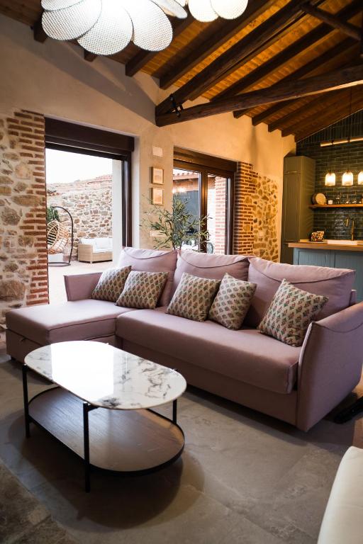 a living room with a couch and a table at El Corral de Cayetana in Valdemierque