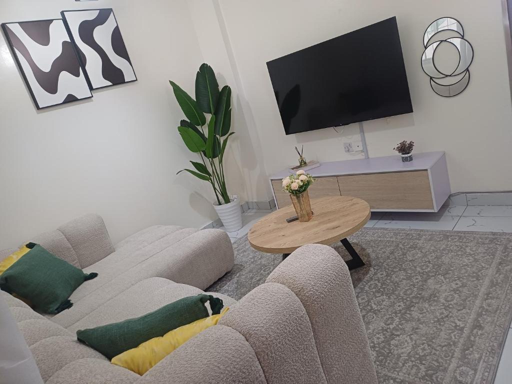 a living room with a couch and a tv at Nas Haven in Mombasa