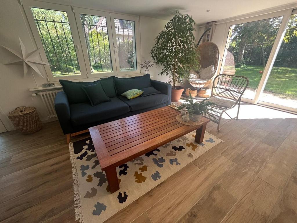 a living room with a couch and a coffee table at Between city and countryside in Maisons-Laffitte