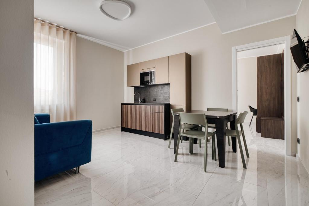 a kitchen and dining room with a table and chairs at Luxury Design Apartment Duomo in Milan