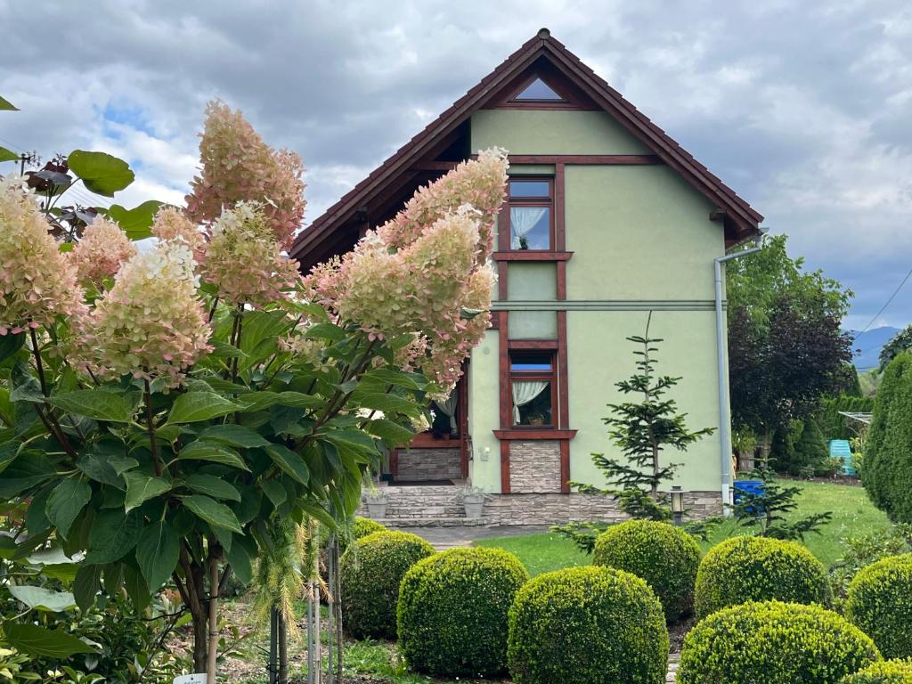 a small house with bushes in front of it at Holiday Resort Švárny in Ružomberok