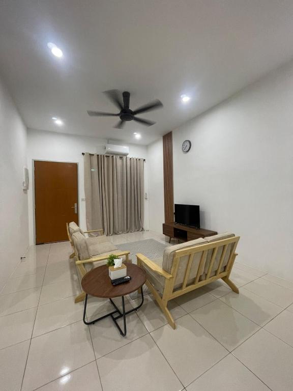 a living room with a couch and a ceiling fan at Simfoni Jitra Homestay in Jitra