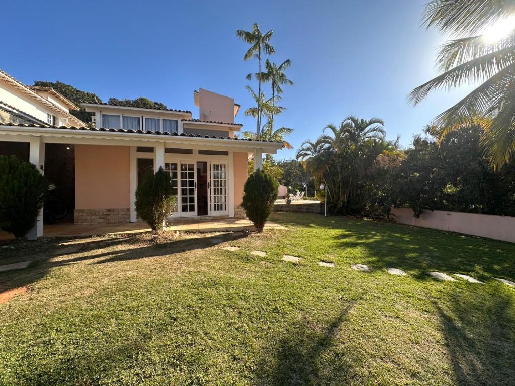a house with a lawn in front of it at Toca da Tartaruga 31, PISCINA PRIVATIVA EXCLUSIVA in Armacao dos Buzios