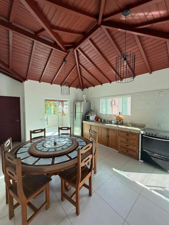 a kitchen with a table and chairs in a room at Búzios Apartamento Paraiso ll in Búzios