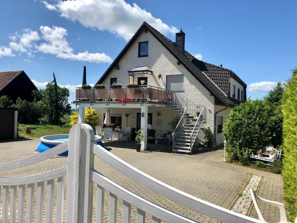 a white fence in front of a house at Brockenblick 