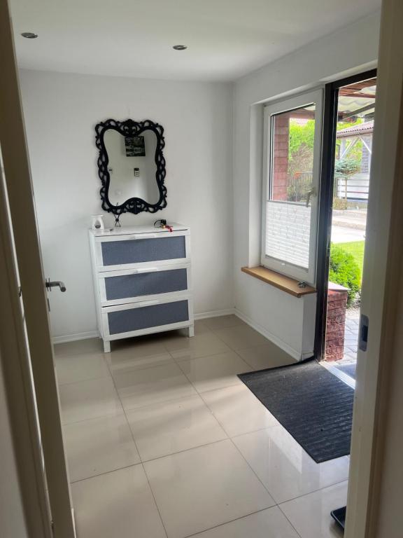 a room with a dresser and a mirror on the wall at Apartament blisko lotniska z prywatnym ogrodzonym parkingiem in Radom