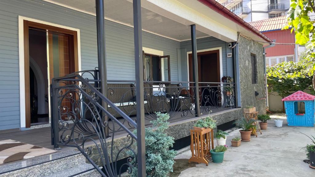 a front porch of a house with a railing at Dream House in Batumi