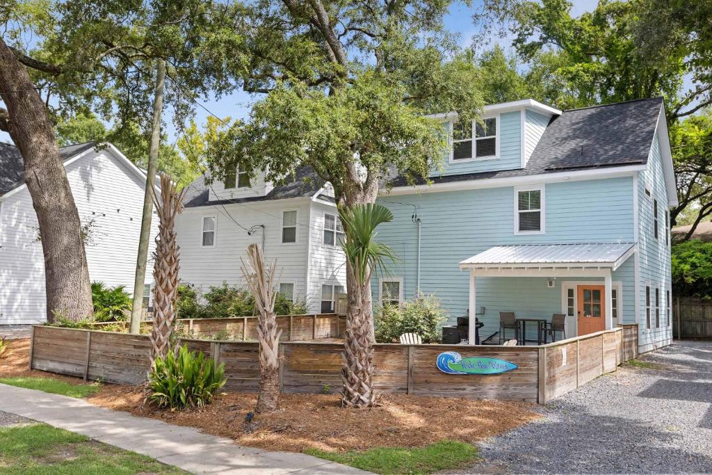a blue house with a wooden fence in front of it at Ride The Wave 5 min to Beach 7 min to Dtwn in Charleston