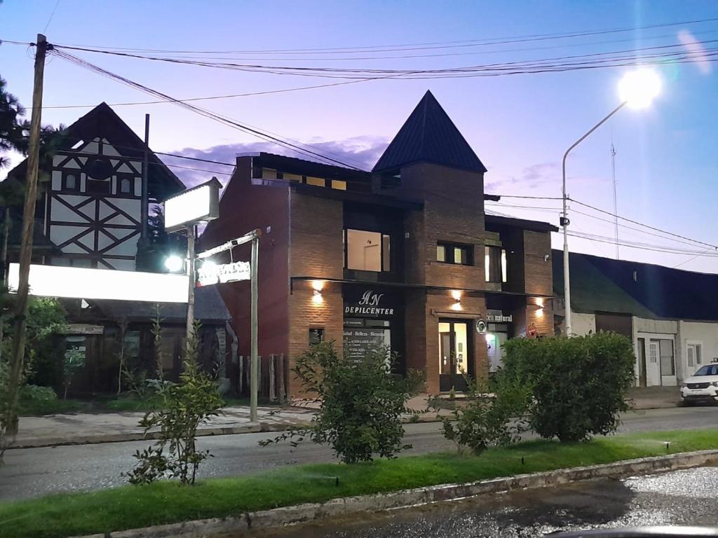 a building on the corner of a street at ARWEN Suites 1 in Trevelin