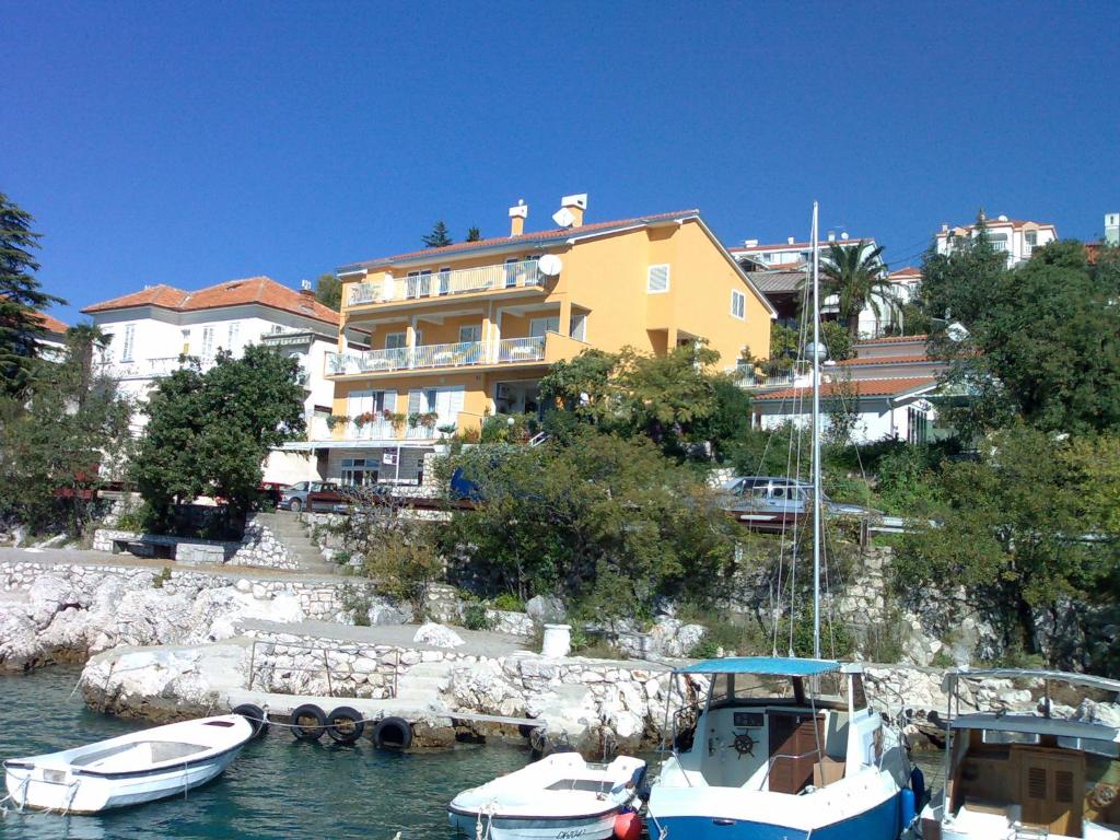 two boats docked in the water in front of a building at Apartments and Rooms Lucia&Veronica in Dramalj