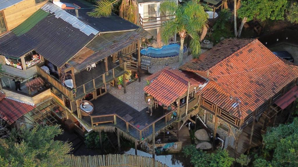 an overhead view of a large house with a pool at Hostel Explorer in Imbituba