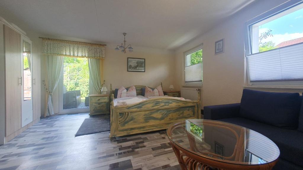 a bedroom with a bed and a couch and a table at Ferienwohnung Stein in Sassnitz