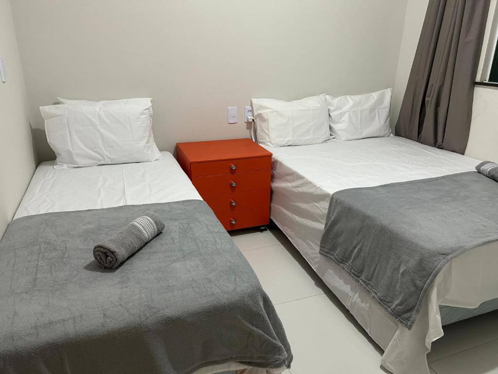 two beds sitting next to each other in a room at Beira do rio com píer e piscina in Barreirinhas