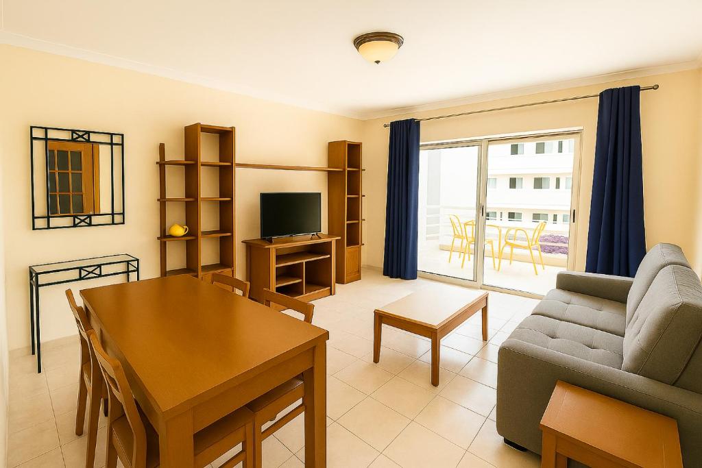 a living room with a couch and a table at 10 min walk to Rocha Beach in Portimão