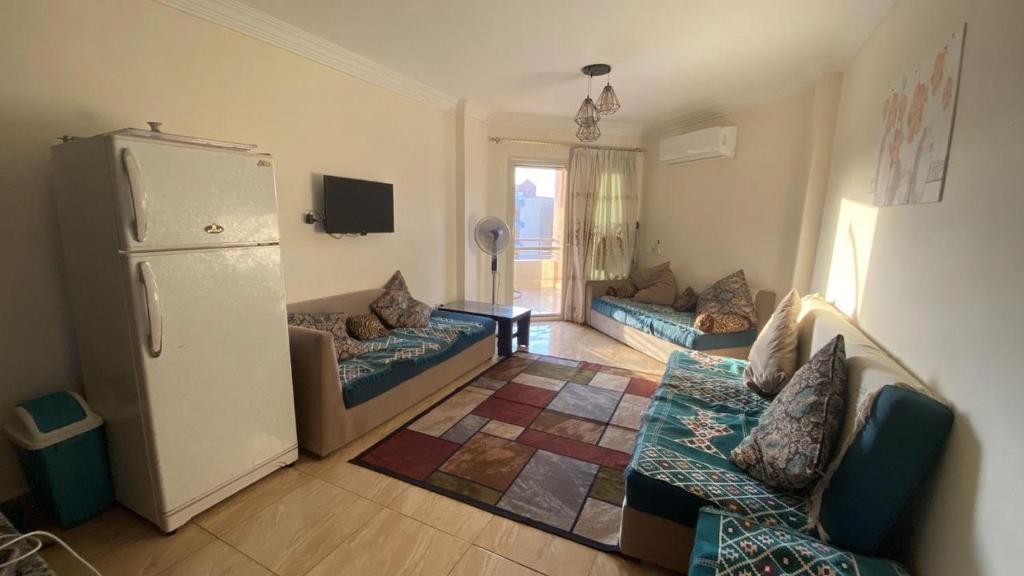 a living room with couches and a refrigerator at قرية لاجولى السخنه للعائلات فقط in Ain Sokhna
