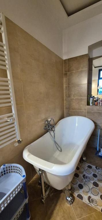 a white bath tub in a bathroom at Retro apartament in Arad