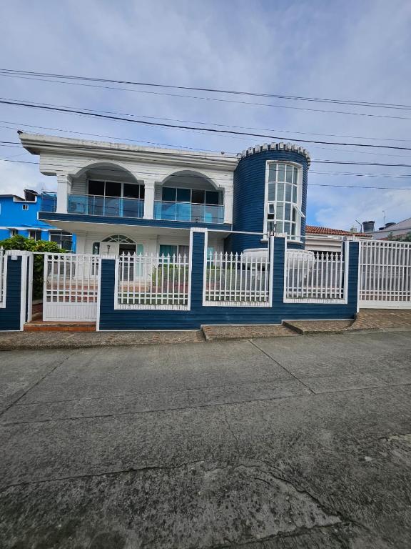 a blue and white house with a white fence at Alojamiento blue castle in San Andrés
