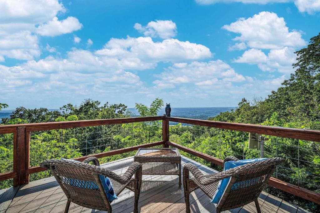 two chairs on a deck with a view of the ocean at Mountain Retreat Ruby's Roost Home & Loft in Mentone