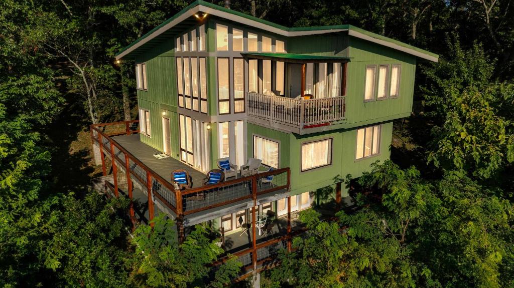 an aerial view of a green house with a balcony at Mountain Retreat Ruby's Roost Home & Loft in Mentone