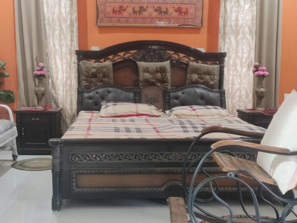 a bed in a room with an orange wall at Green Meadows Homestay in Kakarmatha