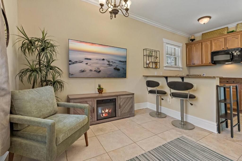 a living room with a fireplace and a chair at Heart of Hyde Park Tampa/Parking/Netflix/Gym in Tampa