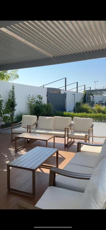 a group of benches and tables on a patio at Aljalal chalet in Billah