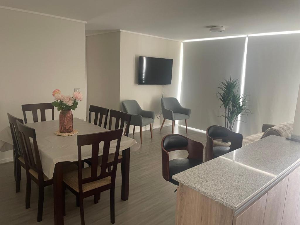 a living room with a dining room table and chairs at Arriendo depto en La Serena condominio Firenze in La Serena