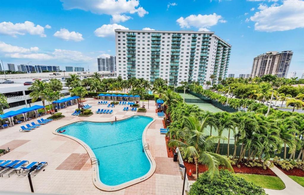 an aerial view of a resort with a pool and palm trees at Ocean reserve 2 bedroom plus den in Sunny Isles Beach