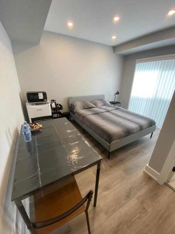a bedroom with a bed and a table in it at Guest Suite in Ottawa in Ottawa