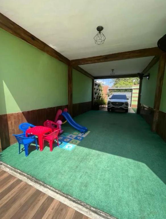 a play room with chairs and a slide at COP30 na Araújo 385 in Ananindeua