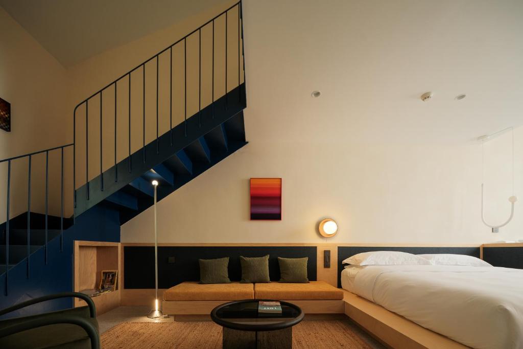 a bedroom with a large bed and a staircase at songzhiyu3平江路 in Suzhou