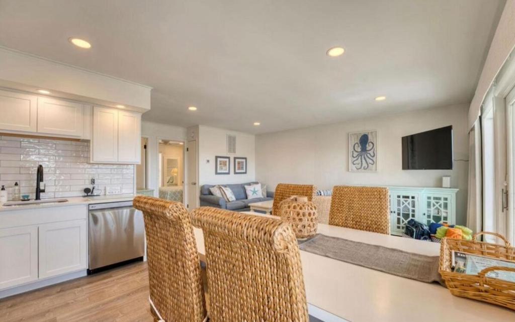 a kitchen and living room with chairs and a couch at JDH Beachfront Retreat in Ocean City