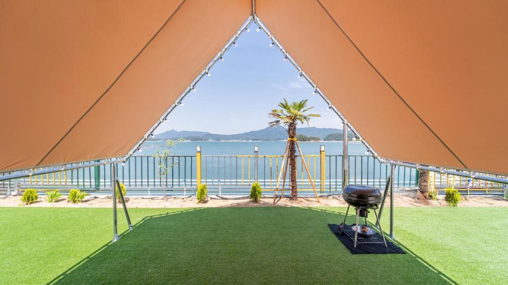 a tent with a view of the ocean at Goseong Bluebeach Pension&Glamping in Goseong