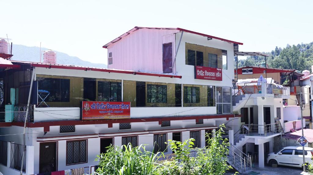 a white building with a sign on the side of it at Siddhi Vinayak Residency By StayApart in Gupta Kāshi