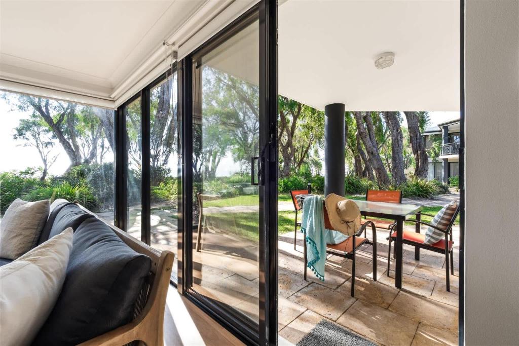 a living room with a couch and a table at 2 CapeView Beachfront Geographe Bay in Broadwater