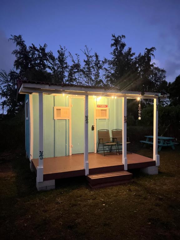 a tiny house with a porch at night at North-Shore Tiny Hales-Oahu, Hawaii in Laie