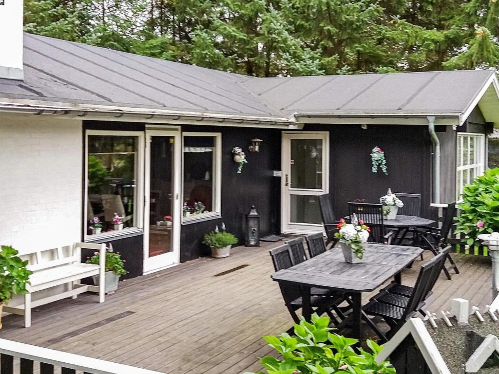 a patio with a table and chairs on a deck at 8 person holiday home in Hals-By Traum in Hals