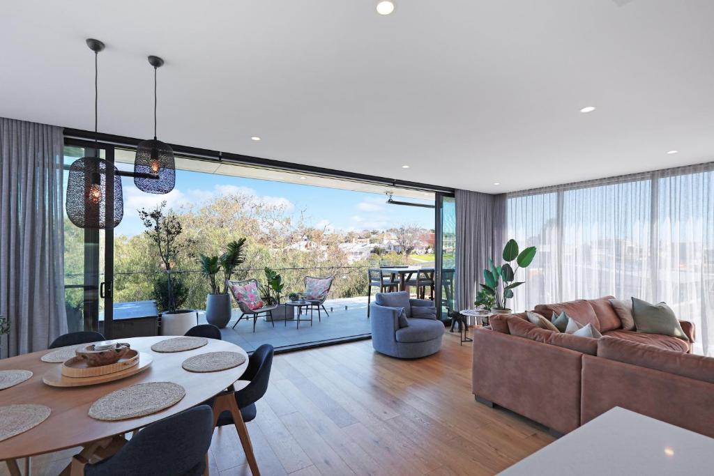 a living room with a couch and a table at 302 Penthouse Portarlington Waterfront Luxury sleeping 6 3 Queen Bedrooms 2 bathrooms Private Terrace Aircon and Heating in Portarlington