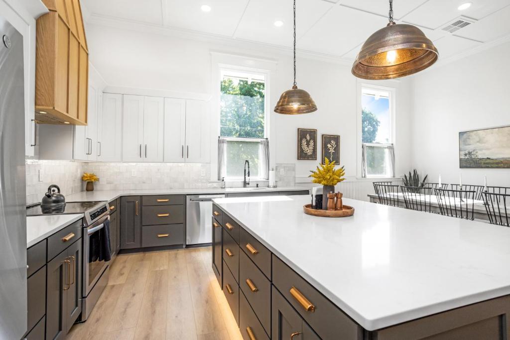 a kitchen with white countertops and brown cabinets at Heritage Heights-Close to Downtown & Pioneer Park in Walla Walla
