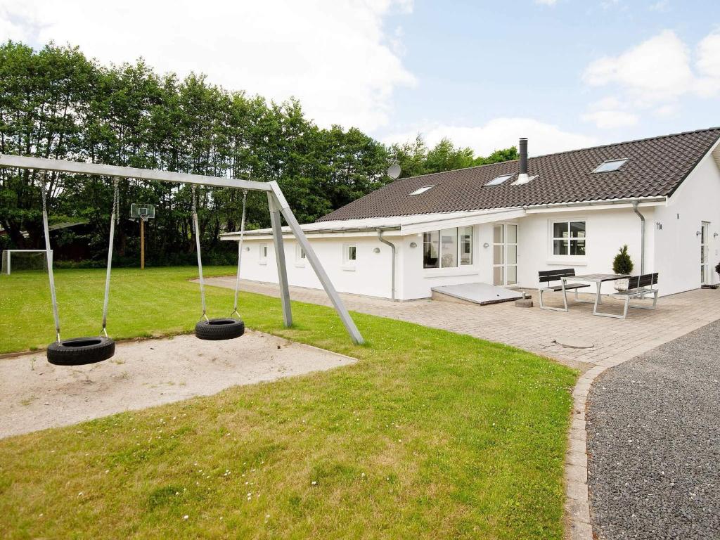 a playground in the yard of a house at 12 person holiday home in Egå-By Traum in Åstrup