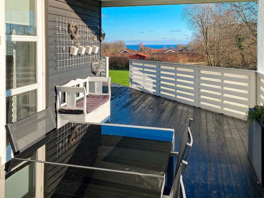a deck with a bench on a house at 6 person holiday home in Sydals in Sarup