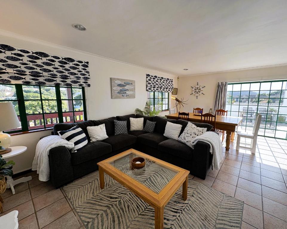 a living room with a couch and a table at The Cinnamons in Plettenberg Bay