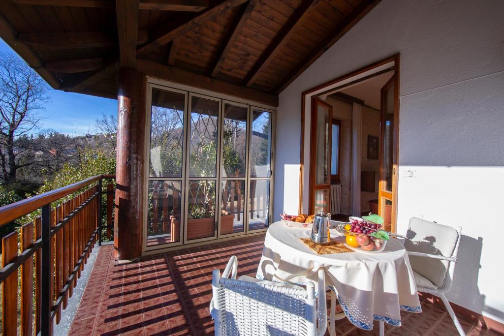 a table on the balcony of a house at Villa La Verbanina Private Garden - Happy Rentals in Ghiffa