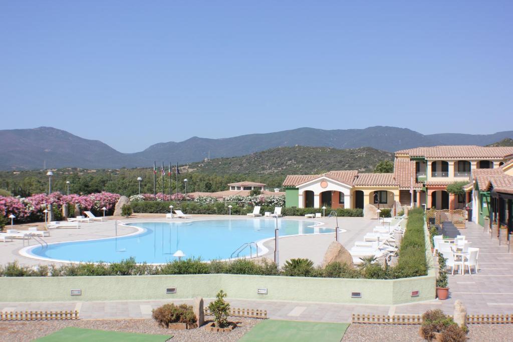 a view of the pool at a resort at Le Vanille in Costa Rei