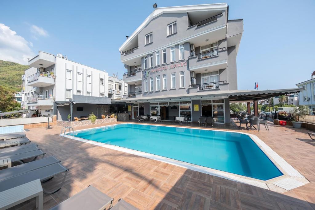 a swimming pool in front of a building at Marina Apart Hotel in Marmaris