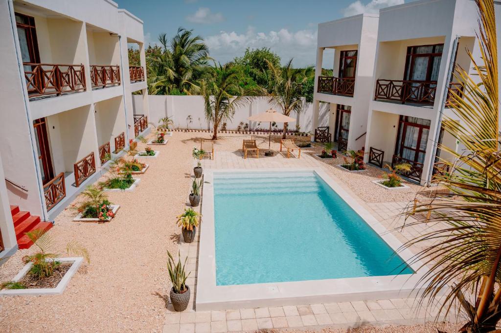 an aerial view of the courtyard of a hotel with a swimming pool at Andy's Inn in Michamvi