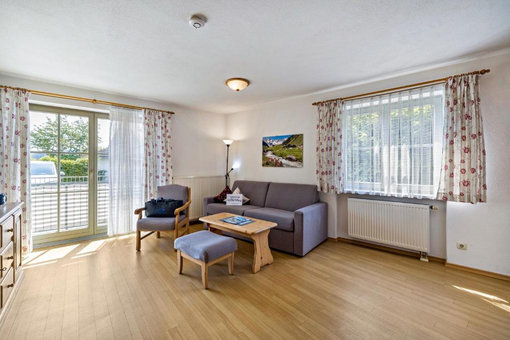 a living room with a couch and a table at Fewo Brünnstein - Nr 5 Pool, Sauna in Oberaudorf