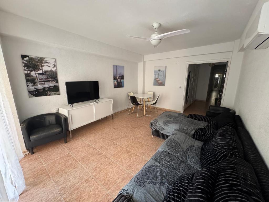 a living room with a couch and a flat screen tv at Paseo marítimo ALMERIA RL in Almería